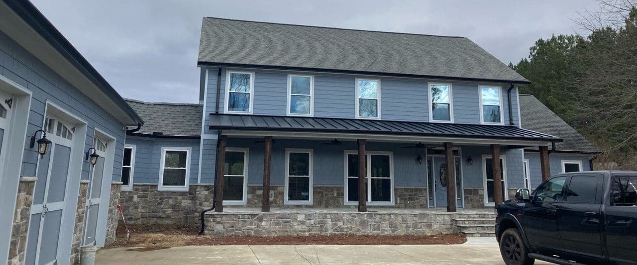 Flat Rock Siding Replacement, Front windows and door replacement, new front stone proch with custom cedar posts & standing seam metal roof